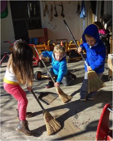 children sweeping outside